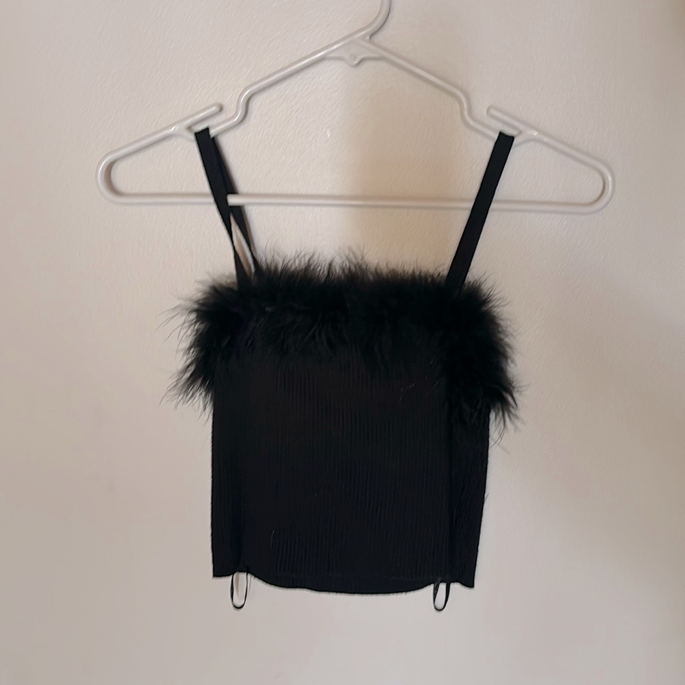 The fabric is ribbed and stretchy, and the top has good quality feathers